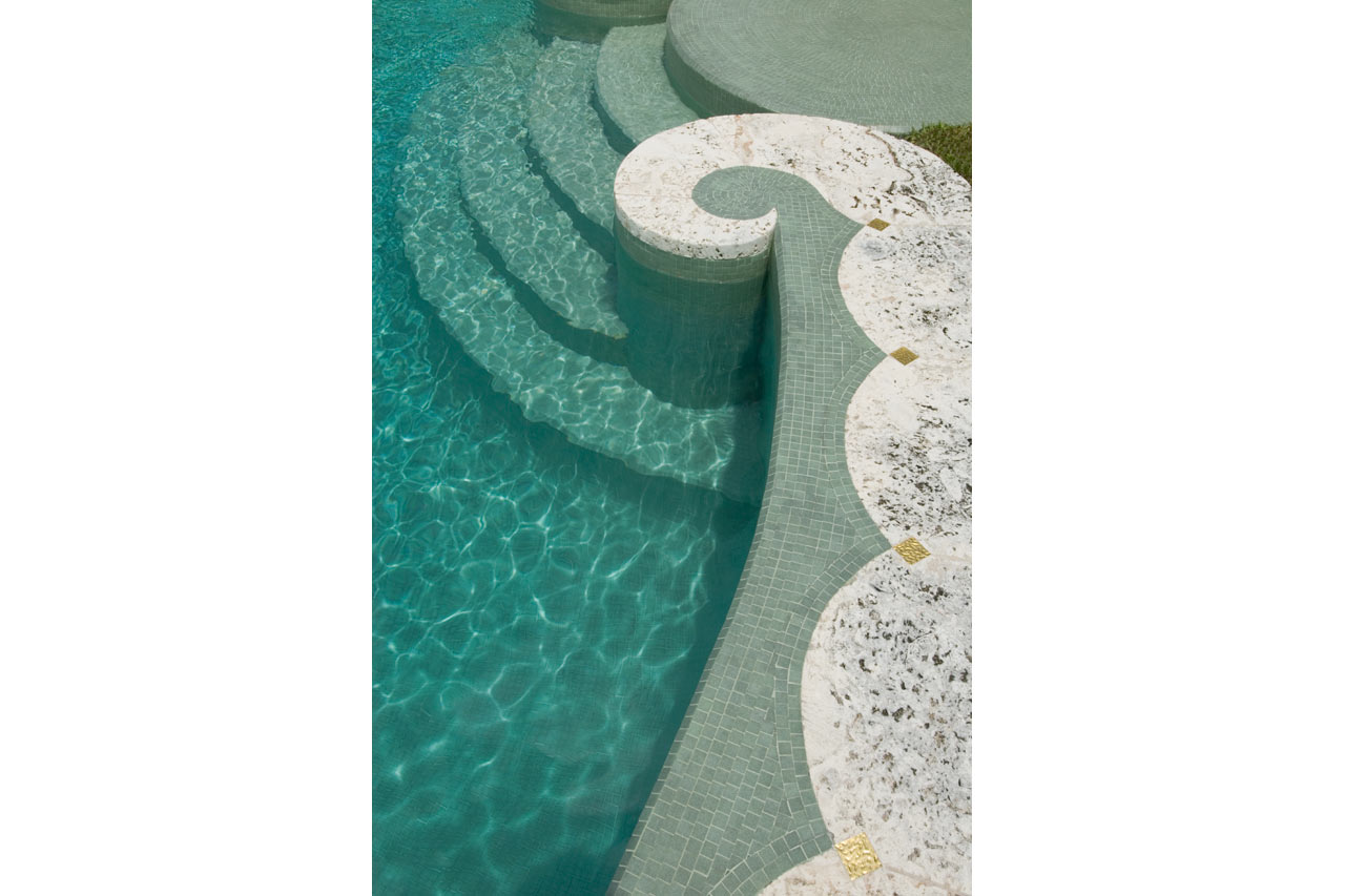 coping detail of an Oval stone & mosaic pool in Miami Beach designed by Maria de la Guardia & Teofilo Victoria of DLGV Architects & Urbanists