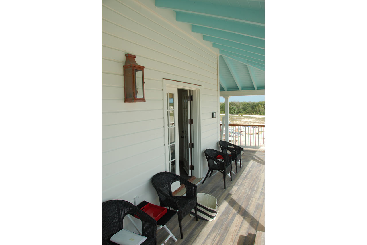 veranda of a Bahamian veranda style lodge designed by Maria de la Guardia & Teofilo Victoria of DLGV Architects & Urbanists