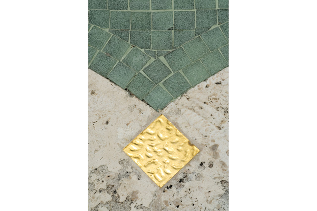 gold leaf detail of an Oval stone & mosaic pool in Miami Beach designed by Maria de la Guardia & Teofilo Victoria of DLGV Architects & Urbanists
