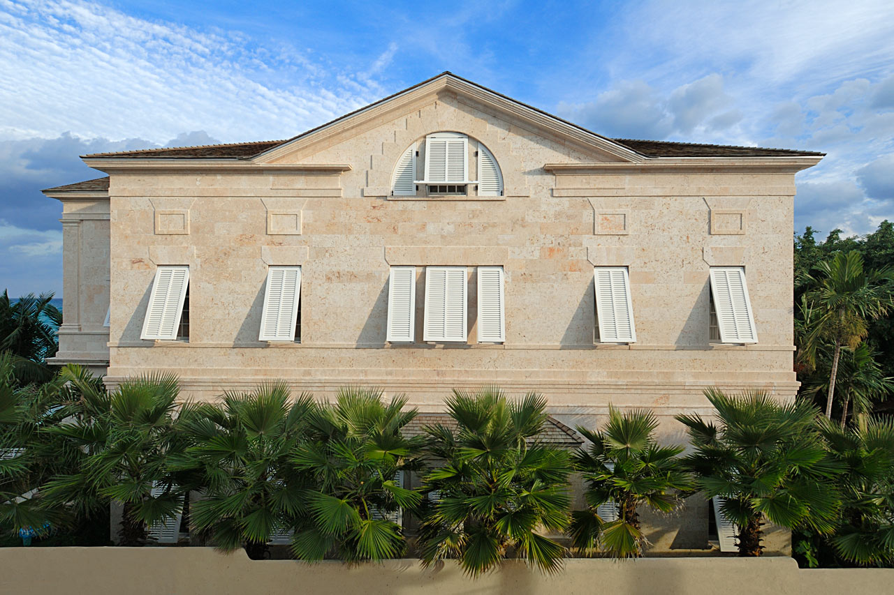 Side Facade of a Palladian beach house in the Bahamas designed by Maria de la Guardia & Teofilo Victoria in the classical tradition built of coral stone